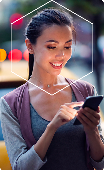 Girl on mobile device smiling with white hexagon around face Girl on mobile device smiling with white hexagon around face