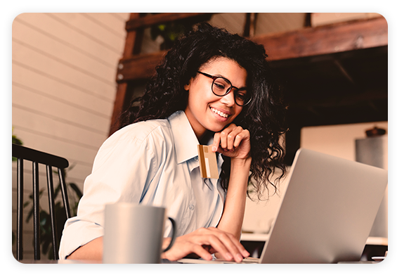 Banking Industry - African American woman looking at laptop and smiling African American woman looking at laptop and smiling